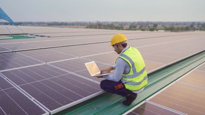 Technician Installing Solar Panels